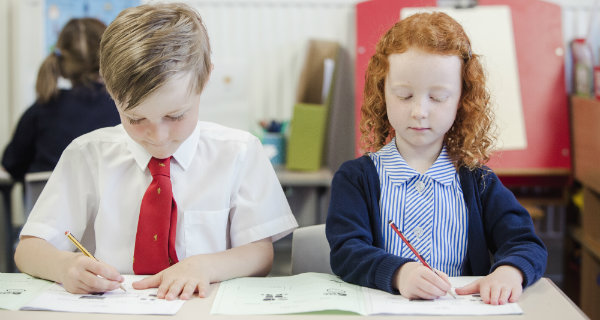 Primary 1 children learning at desk