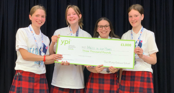 Winning YPI group holding cheque for their charity